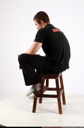 Alex Sitting With Pistol Pose